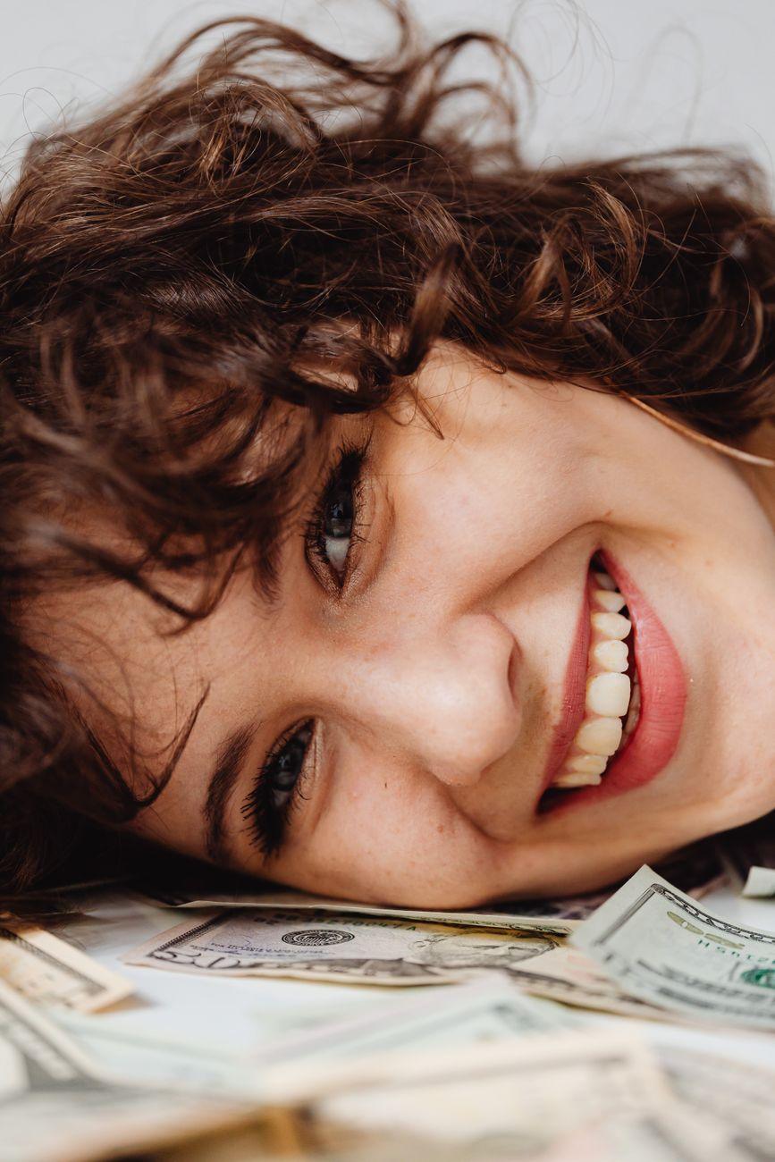 A person looking at a growth chart representing the transition from superficial spending to building genuine wealth.