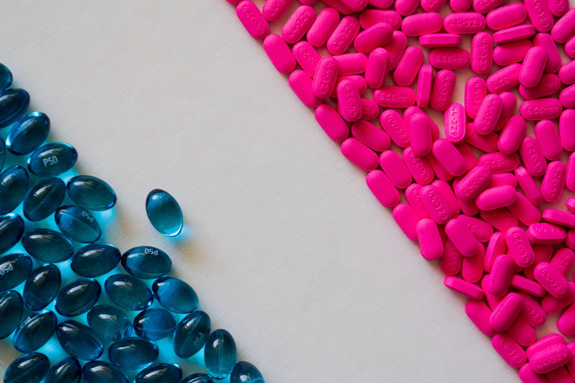A doctor holding a bottle of ibuprofen tablets, symbolizing the risks and side effects of the medication.