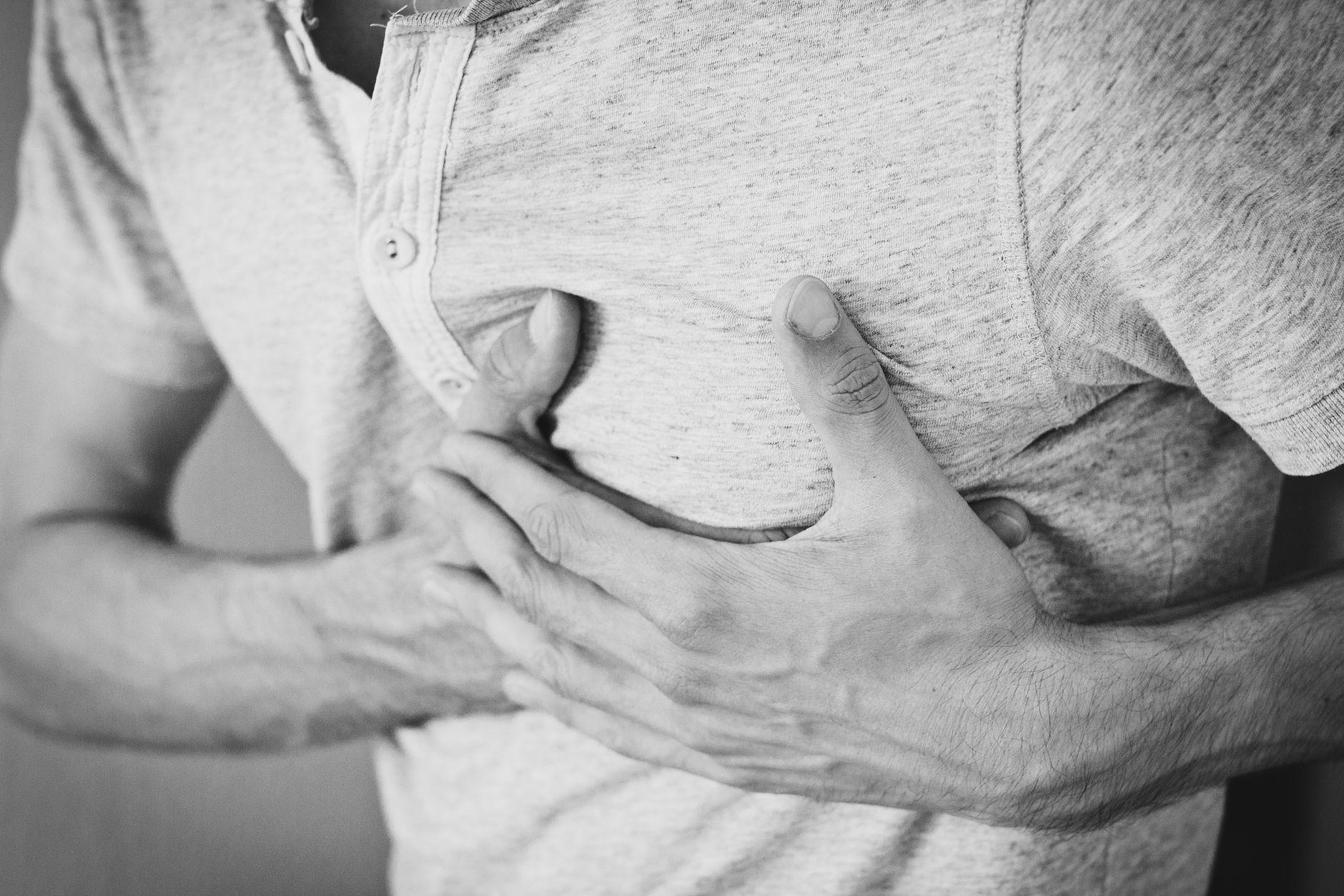 A stressed professional sitting at a desk, representing the need to prioritize heart health and recovery.